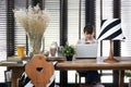 Young asian working woman is using a laptop with vintage decoration