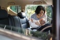 mother putting her little baby son into car seat Royalty Free Stock Photo