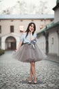 Young Asians girl with modern dress posing in an old Krakow