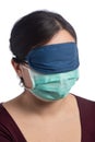 Young asiatic woman wearing a protection mask and a sleeping mask on a white background