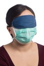 Young asiatic woman wearing a protection mask and a sleeping mask on a white background