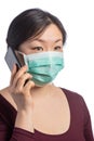 young asiatic woman wearing a protection mask making a phone call on a white background