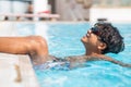 young asina boy jumping into the swimming pool Royalty Free Stock Photo