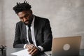 A young aspiring African-American investor works at a computer, analyzes the securities market