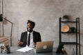 A young aspiring African-American investor works at a computer, analyzes the securities market