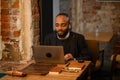 a young aspiring African-American investor works at a computer, analyzes the securities market