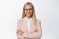 Young aspiring businesswoman, looking confident in glasses and suit, standing like professional, white background