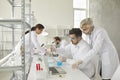 Young and senior adult male scientific researchers working in modern laboratory Royalty Free Stock Photo