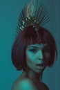 Young astonished african american woman in stylish headpiece