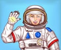 Young astronaut girl in a space suit waving her hand