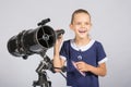 Young astronomer happily standing on the starry sky