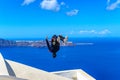 Young athlete back flips during Parkour and Free running. Professional athlete performing a backflip on a roof in Santorini, Royalty Free Stock Photo