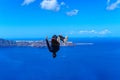 Young athlete back flips during Parkour and Free running. Professional athlete performing a backflip on a roof in Santorini, Royalty Free Stock Photo