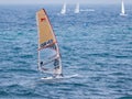 Young athlete in a black tracksuit exercising in windsurfing in the Mediterranean sea in Nahariya, Israel Royalty Free Stock Photo