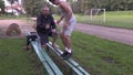 Young athlete do push ups and exercises on stadium