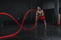 Young athlete doing battle ropes exercise at the crossfit gym Royalty Free Stock Photo