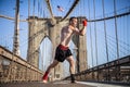 Young athlete fighter exercising on Brooklyn bridge