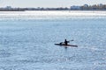 A young athlete guy is practicing sports rowing on a kayak