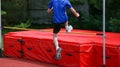 Young athlete jumping over a high jump bar Royalty Free Stock Photo
