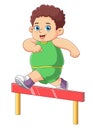 Young athlete jumping over a hurdle
