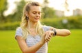 Athlete woman at park checking her smartwatch