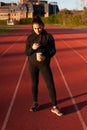 young athlete looks at the mobile while having a coffee