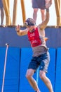 Young athlete participant in a race of heroes jumps from a bungee