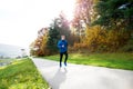 Young athlete running in park in colorful autumn nature. Royalty Free Stock Photo