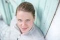 A young athlete stands in front of a turquoise door looking up into the camera Royalty Free Stock Photo