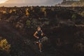 Young athlete trailrunning in mountains at sunrise