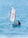 Young athlete trains on an entry-level sports sailing boat