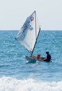 Young athlete trains on an entry-level sports sailing boat