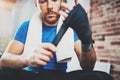 Young athlete tying black boxing bandages.Boxer man concentrating before kickboxing training. Blurred background Royalty Free Stock Photo