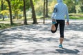 Young athlete woman streching in the park outdoor, female runner warm up ready for jogging on the road outside, asian Fitness walk Royalty Free Stock Photo