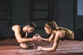 Young athletes giving high five to each other while doing push ups