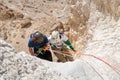 Young athletes start pair downhill using snapping gear in the mountains of the Judean Desert near the Tamarim stream near