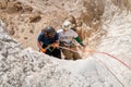 Young athletes start pair downhill using snapping gear in the mountains of the Judean Desert near the Tamarim stream near