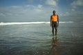 Young athletic and attractive african american sport man posing relaxed outdoors at the beach after fitness workout standing cool