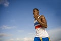 Young athletic and attractive black African American runner man doing running workout training on desert beach in fitness and Royalty Free Stock Photo