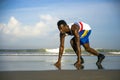 Young athletic and attractive black African American runner man doing running workout training on desert beach in fitness and Royalty Free Stock Photo