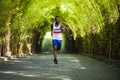 Young athletic and attractive black African American runner man doing running workout training outdoors on urban city park in Royalty Free Stock Photo