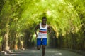 Young athletic and attractive black afro American runner man doing running workout training outdoors on urban city park in fitness Royalty Free Stock Photo
