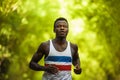 Young athletic and attractive black afro American runner man doing running workout training outdoors on urban city park in fitness Royalty Free Stock Photo