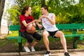 Young Athletic Couple Having Conversation on Bench