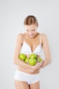 Young athletic girl holding a green apple. Diet and Fitness Royalty Free Stock Photo