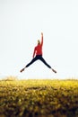 Young athletic girl in a jump with hand raised up. The concept of sport, healthy lifestyle and successfull