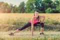 Young athletic girl stretching before jogging