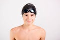 Young athletic healthy teenager ready to swim with swimming goggles and cap