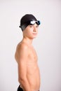 Young athletic healthy teenager ready to swim with swimming goggles and cap