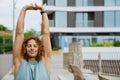 Young athletic long-haired handsome smiling man stretching his arms Royalty Free Stock Photo